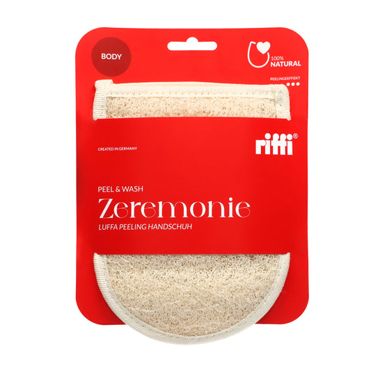 Produktverpackung des riffi Zeremonie Luffa Peeling Handschuhs mit rotem Hintergrund, 100 % Naturmaterial, hergestellt in Deutschland, für Körperpflege und Peelingeffekt.